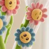 Pink and blue flower-shaped plush curtains with smiling face expressions and green stems and leaves Application Scenario
